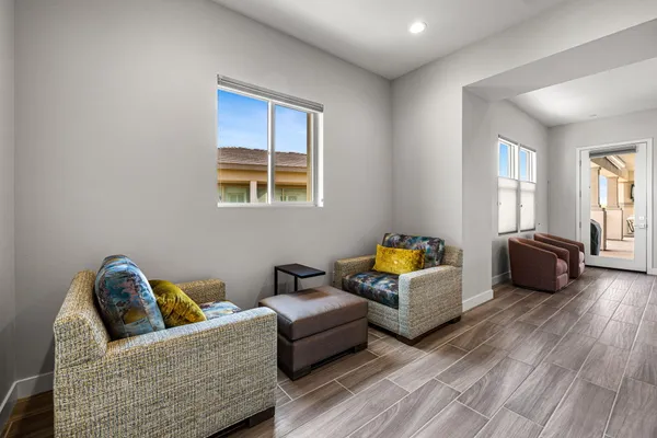 a view of a hallway view with wooden floor and living room