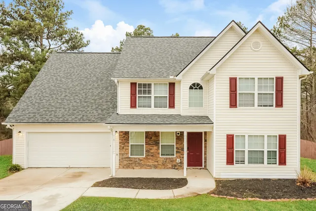a front view of a house with a yard