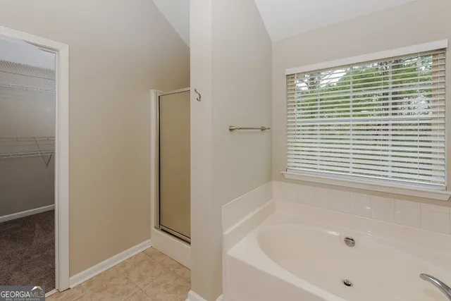 a bathroom with a bathtub and shower