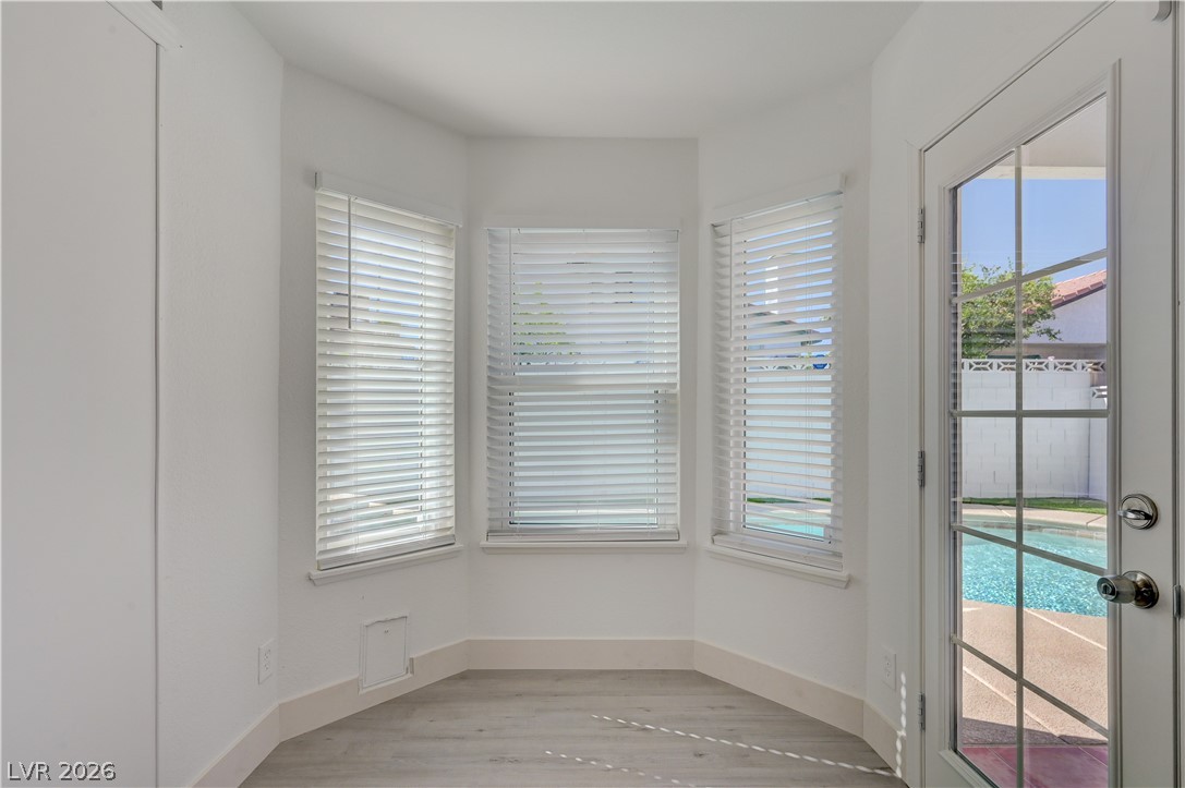 6505 Deadwood Road Las Vegas, NV 89108 - Photo 26 of 33 A well-lit corner features ample natural illumination from multiple windows and a glass-paneled door.