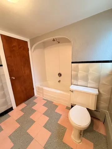 a bathroom with a toilet and a shower