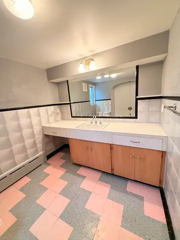 a bathroom with a double vanity sink and a mirror