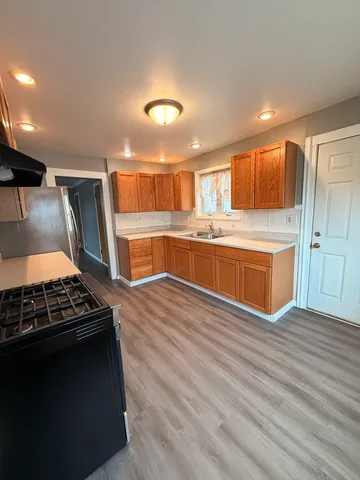 a kitchen with stainless steel appliances granite countertop a stove and a refrigerator