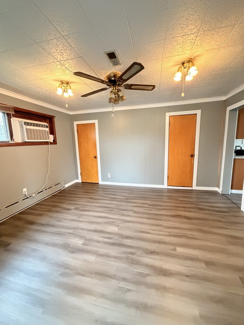 106 Main Street Lostant, IL 61334 - Photo 6 of 18 a view of a room with a ceiling fan and wooden floor