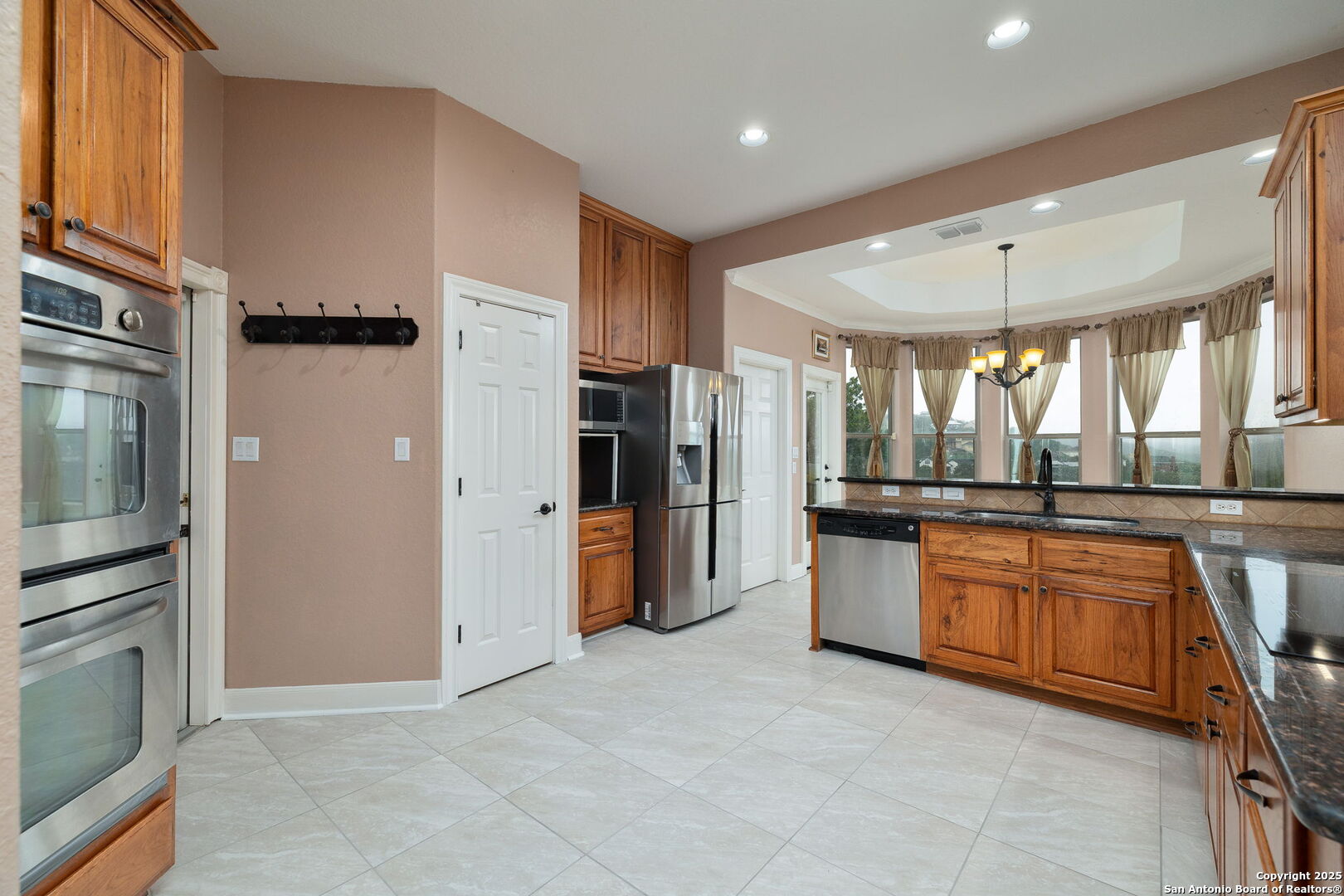 11235 Indian Caves Helotes, TX 78023 - Photo 12 of 45 a kitchen with stainless steel appliances granite countertop a refrigerator and a sink