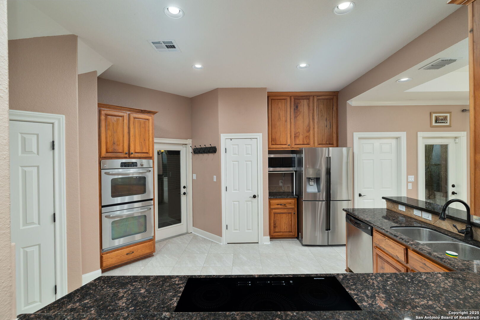 11235 Indian Caves Helotes, TX 78023 - Photo 13 of 45 a living room with stainless steel appliances kitchen island granite countertop a refrigerator and a stove top oven