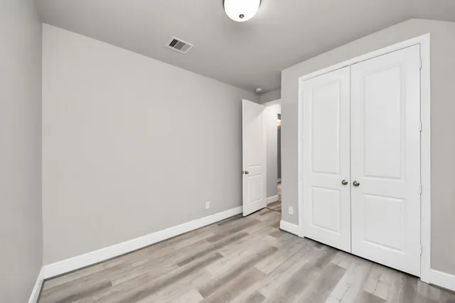 wooden floor in a hall with a window