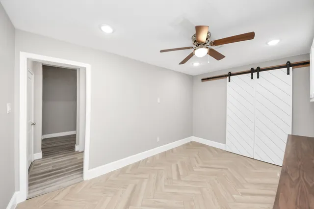 a bathroom with a sink mirror vanity and toilet
