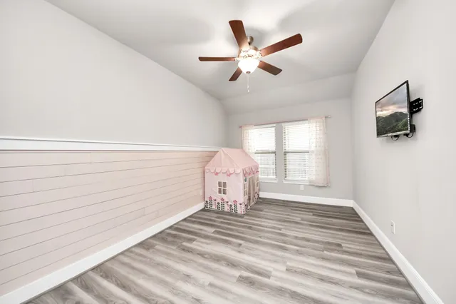 a view of a hallway with a flat screen tv