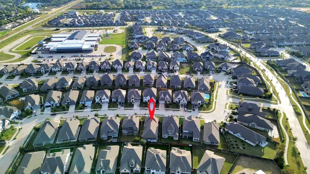 a view of a hallway with wooden floor and a chandelier