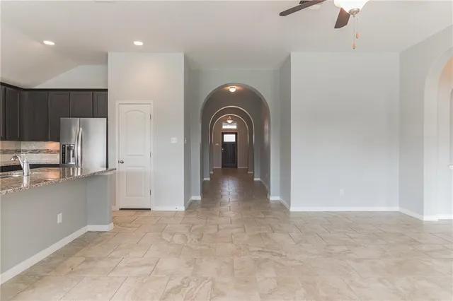 a view of a kitchen with a sink and a refrigerator
