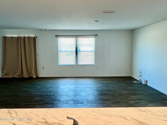 a view of lot of kitchen and wooden floor