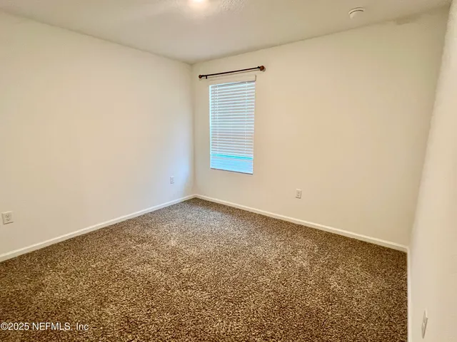 an empty room with a windows