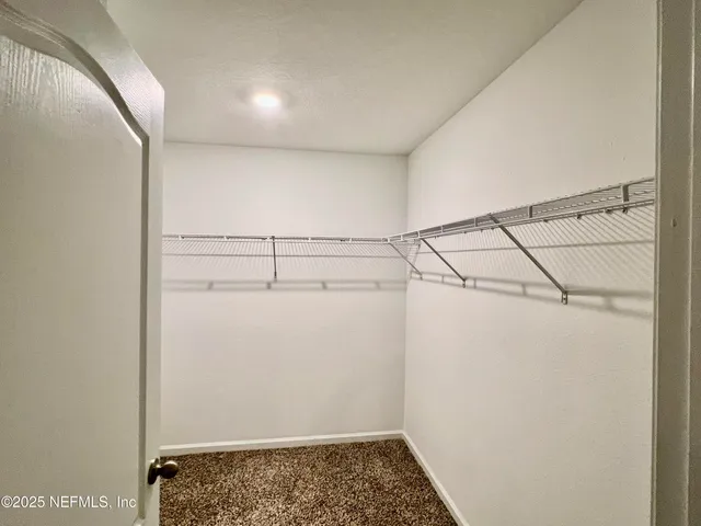 a view of storage and utility room with racks on the wall