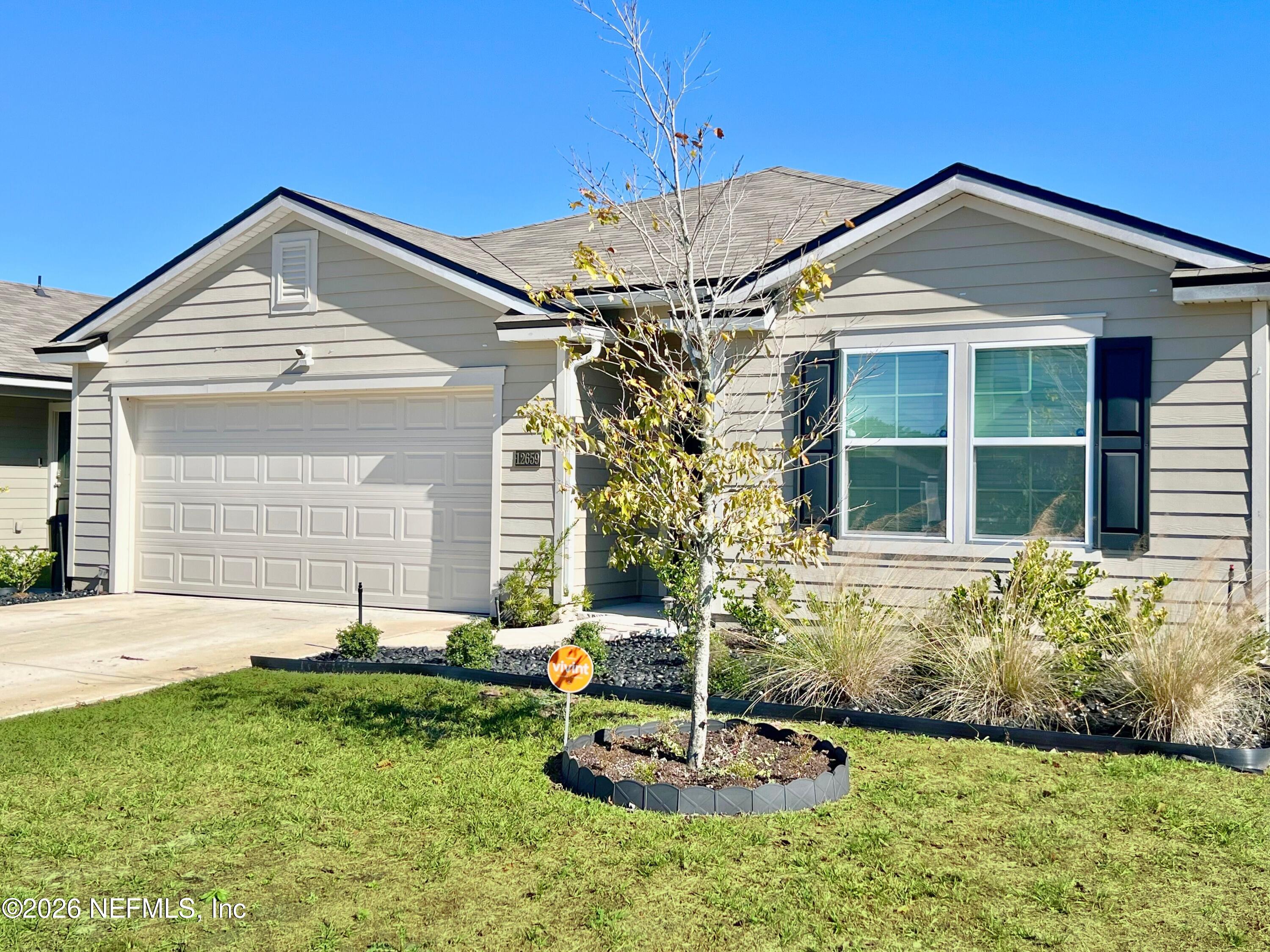 12659 European Beech Road Jacksonville, FL 32218 - Photo 3 of 30 a front view of a house with a yard