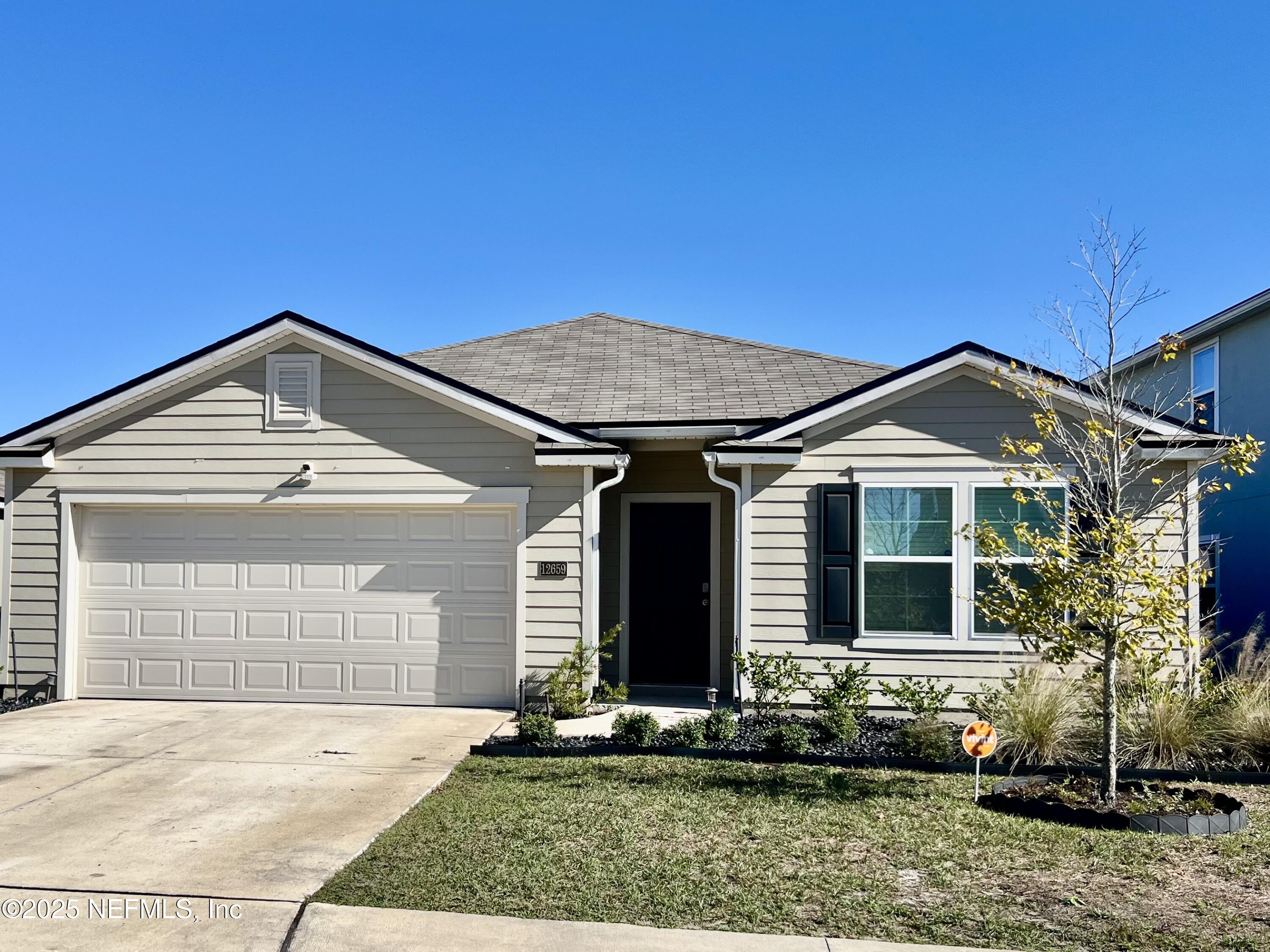 12659 European Beech Road Jacksonville, FL 32218 - Photo 4 of 30 a front view of a house with a yard