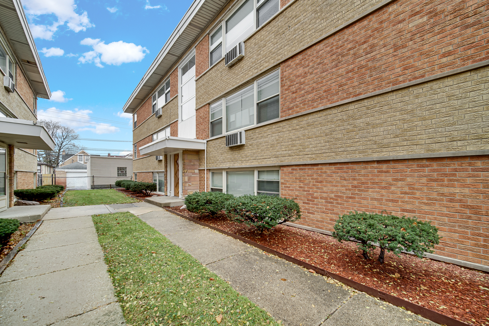 3725 North Harlem Avenue, Unit F Chicago, IL 60634 - Photo 13 of 15 a front view of a house with a yard and potted plants