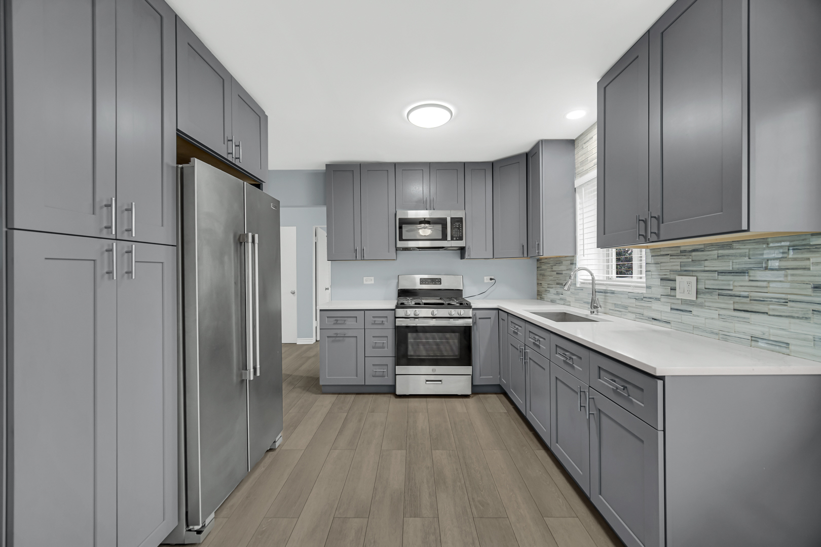 3725 North Harlem Avenue, Unit F Chicago, IL 60634 - Photo 2 of 15 a kitchen with stainless steel appliances granite countertop a refrigerator stove and sink