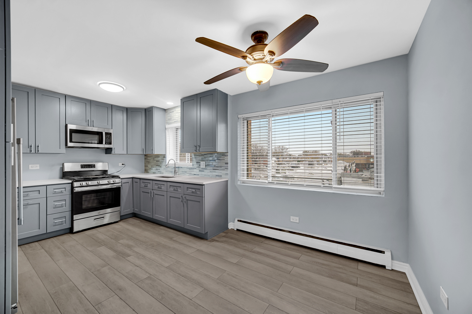 3725 North Harlem Avenue, Unit F Chicago, IL 60634 - Photo 3 of 15 a kitchen with granite countertop stainless steel appliances a stove cabinets and a refrigerator
