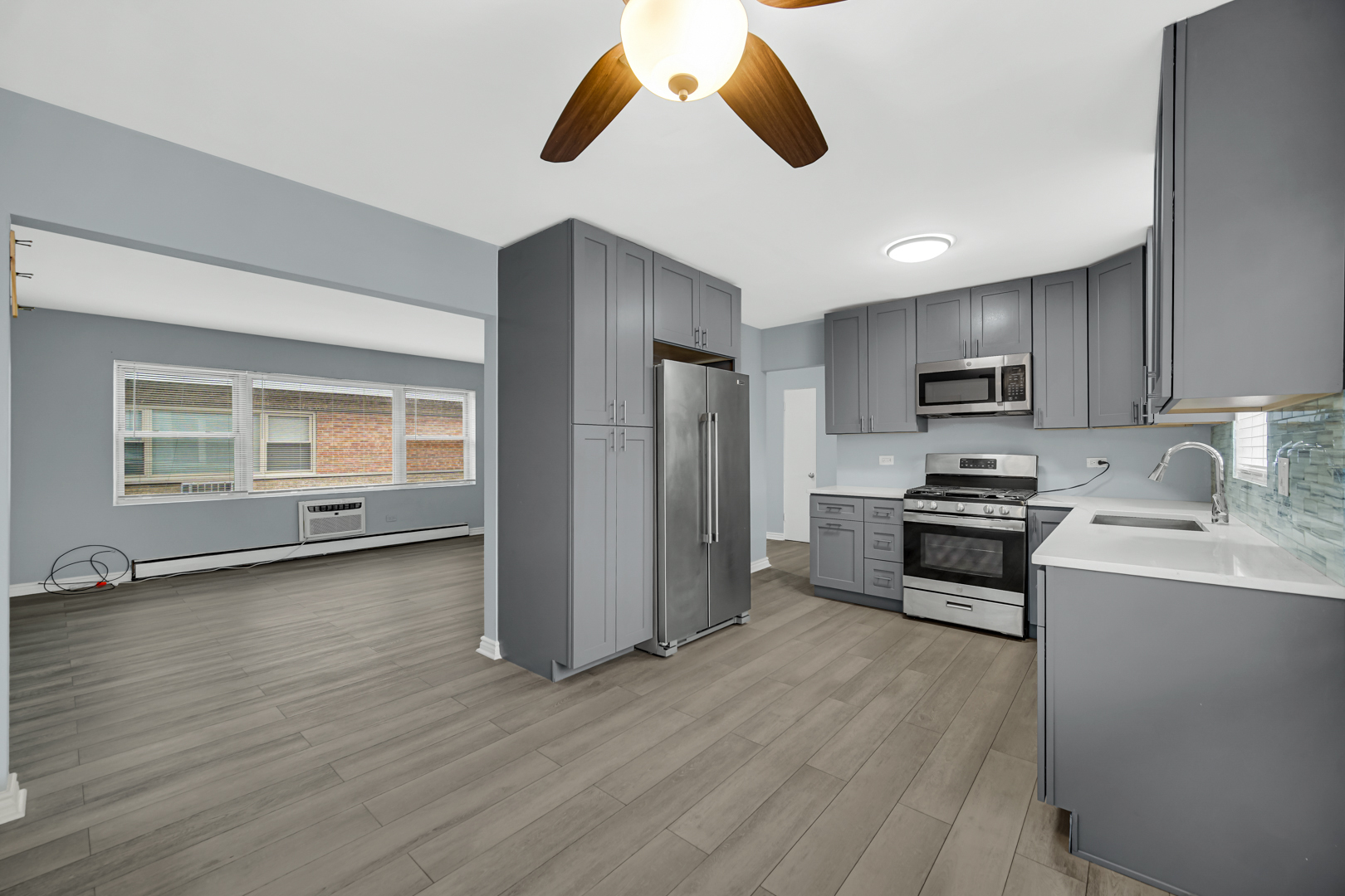 3725 North Harlem Avenue, Unit F Chicago, IL 60634 - Photo 4 of 15 a kitchen with stainless steel appliances granite countertop a stove a sink and a refrigerator