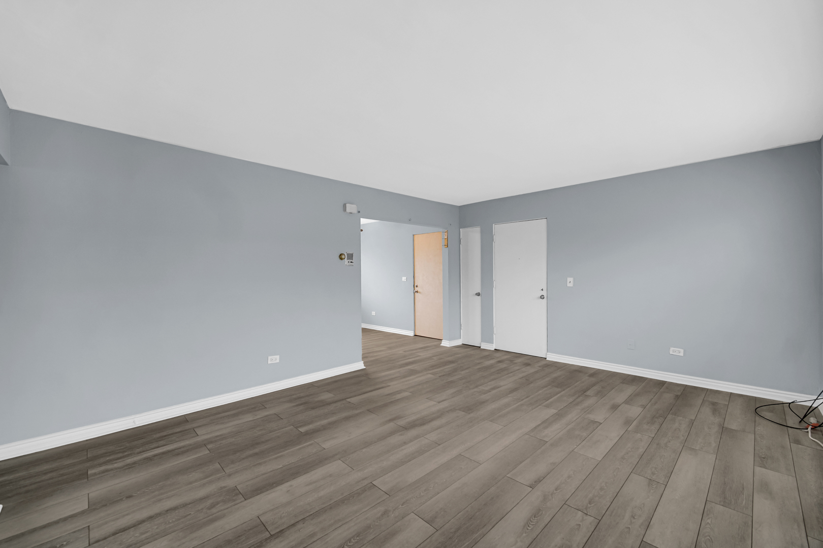 3725 North Harlem Avenue, Unit F Chicago, IL 60634 - Photo 6 of 15 a view of an empty room with wooden floor