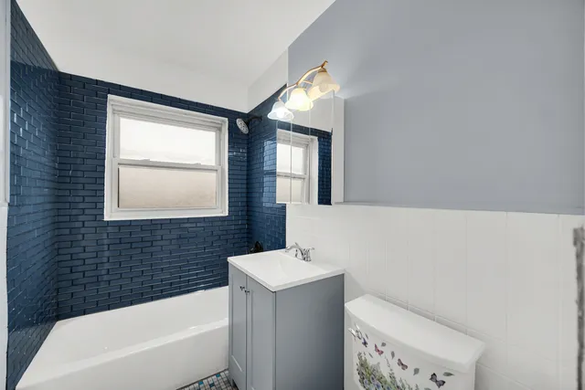 a bathroom with a sink a toilet and bathtub