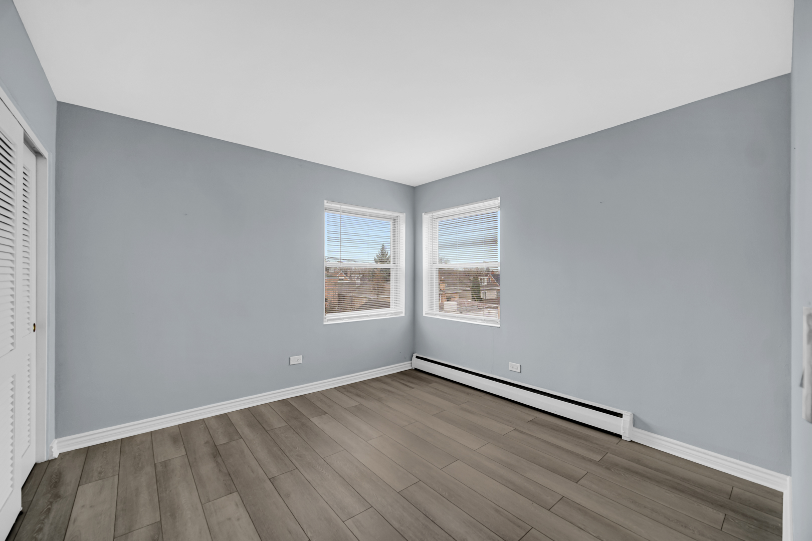 3725 North Harlem Avenue, Unit F Chicago, IL 60634 - Photo 10 of 15 an empty room with wooden floor and windows