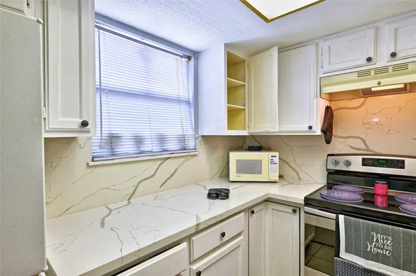 a kitchen with stainless steel appliances granite countertop a sink and cabinets
