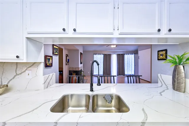 a kitchen with a refrigerator and a sink