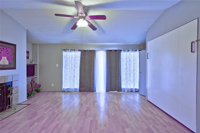 a view of closet with window and wooden floor