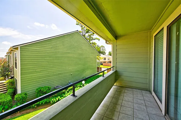 a view of an empty room with closet and a window