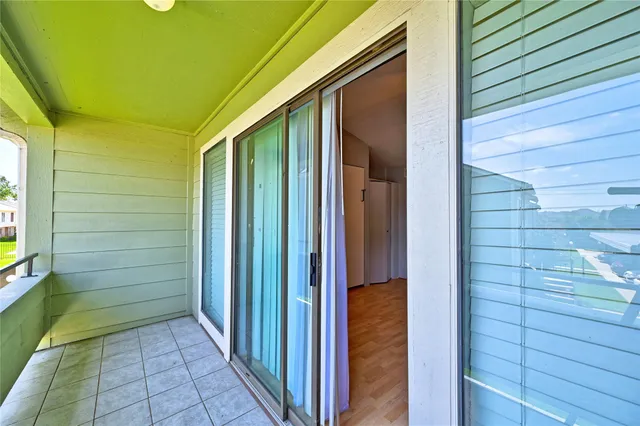a spacious bedroom with a table and a dresser
