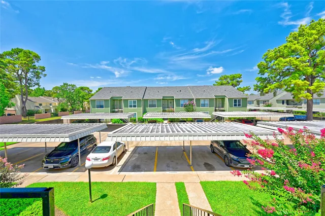 a view of a patio with table and chairs under an umbrella