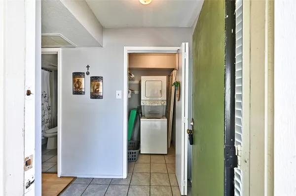 a view of a hallway with wooden shelves