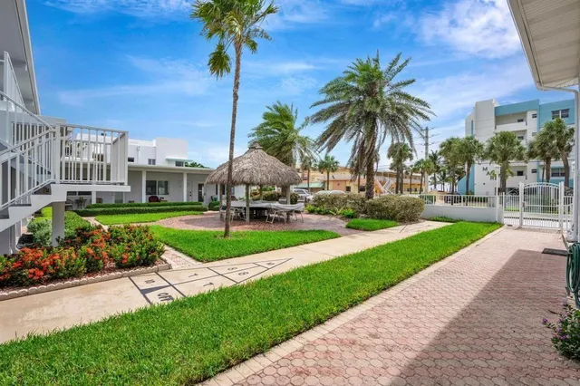 a front view of a house with yard and hallway