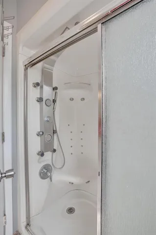 a bathroom with a glass shower door