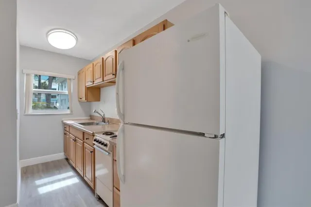 a kitchen with stainless steel appliances granite countertop a refrigerator and a stove