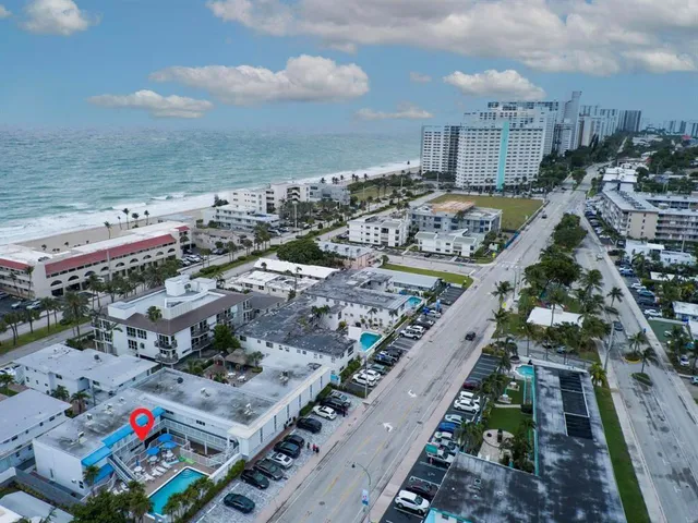 an aerial view of multi story residential apartment building with garage