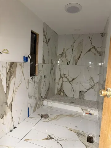 a bathroom with a bathtub and shower