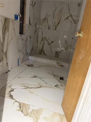 a white toilet sitting next to a bath tub