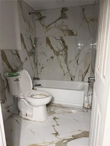 a view of livingroom with furniture and a refrigerator