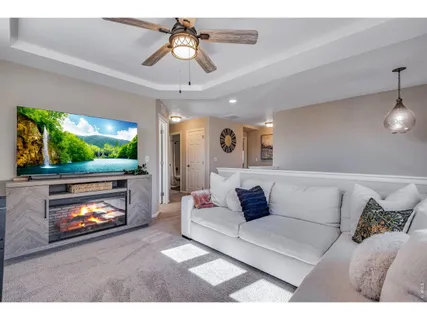 a living room with furniture and a chandelier