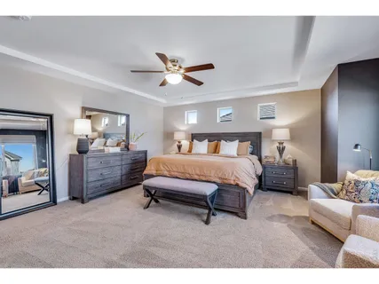 a bedroom with a bed and a chandelier