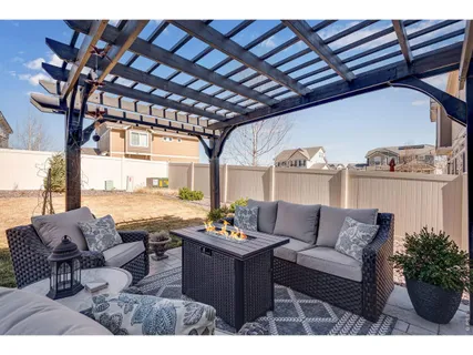 a living room with lots of furniture and a potted plant