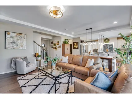 a living room with furniture and kitchen view