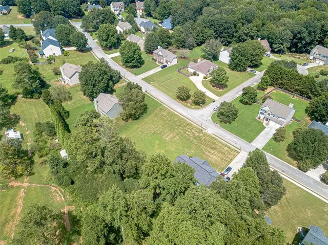 an aerial view of a house with a yard