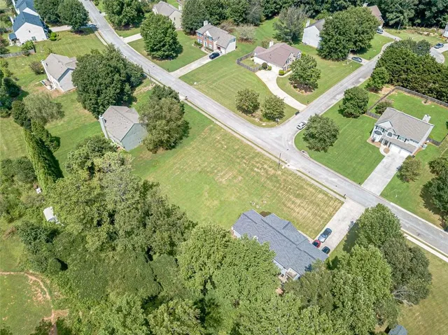 an aerial view of a house with a yard