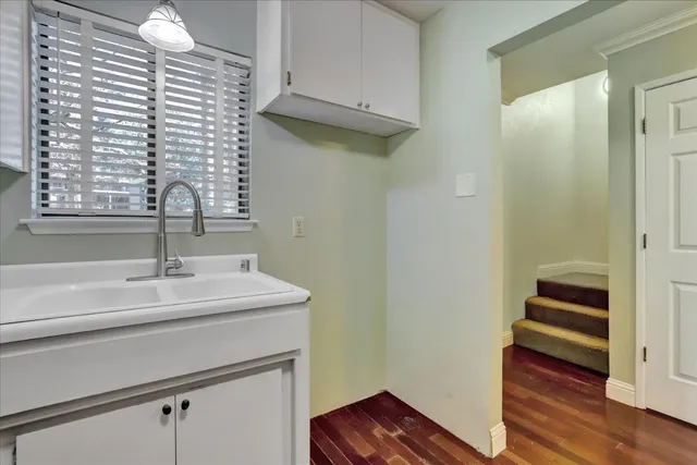 a view of a room with wooden floor