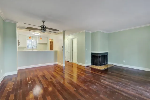 a view of an empty room with wooden floor