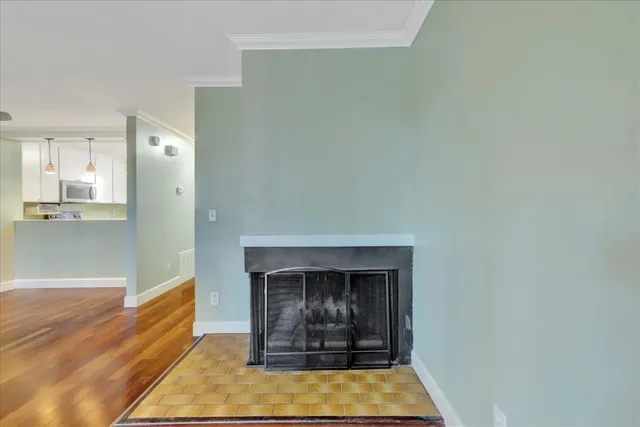 a view of a big room with wooden floor and windows